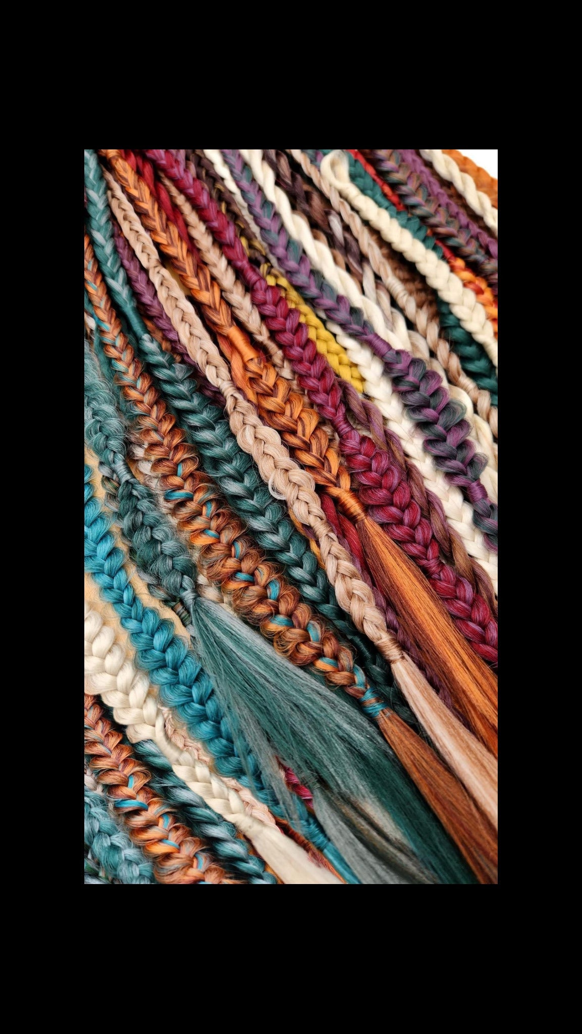 Close-up of braided hair in various colors